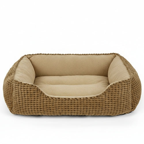 Dog lying on a brown pet bed with a white background